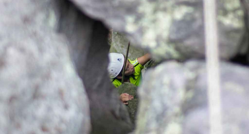 girl navigates route while rock climbing